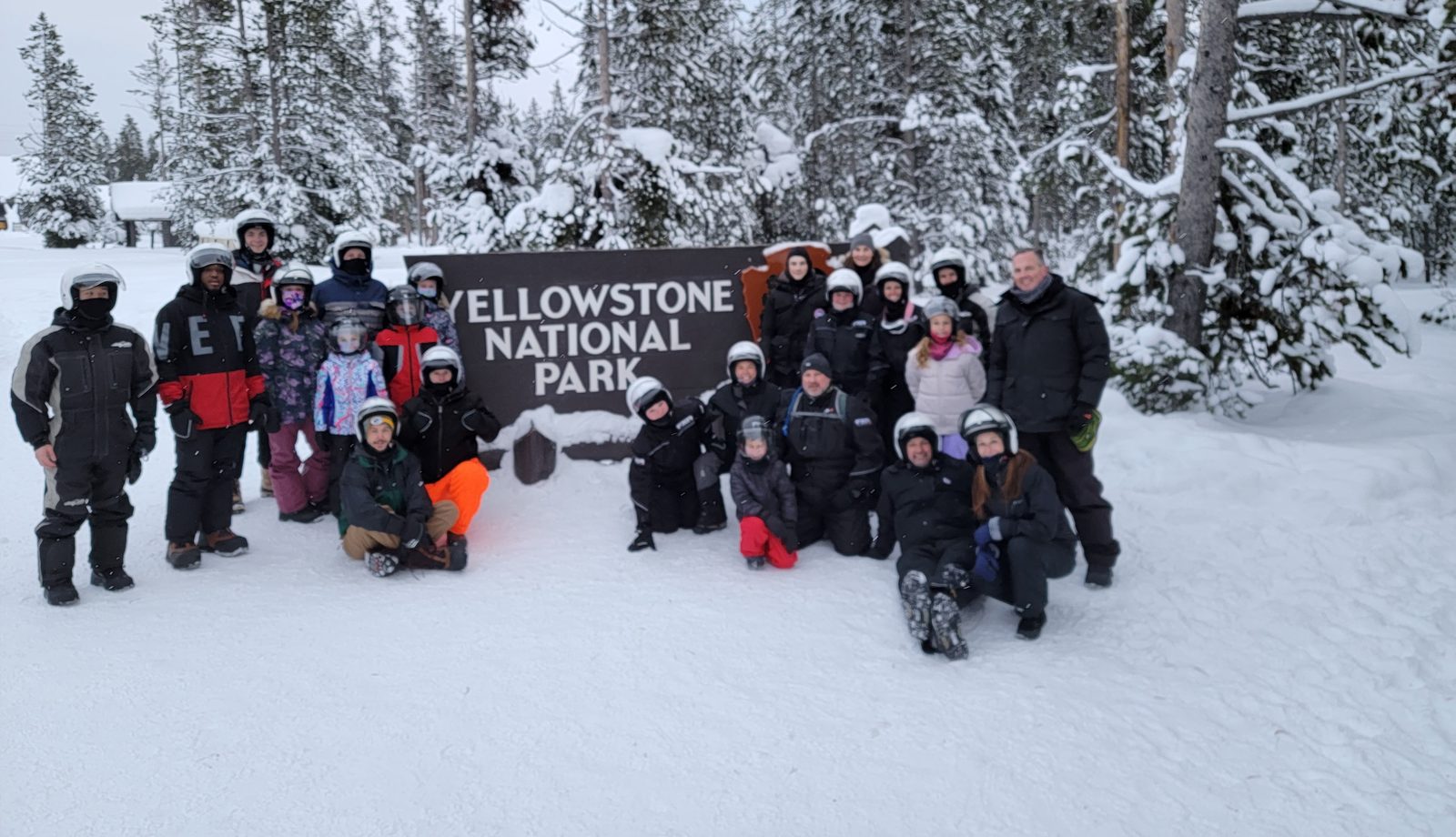 The group at the Yellowstone National Park sign on a Fuel Retreat